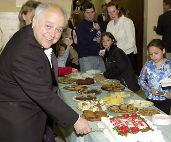 Paul cuts cake in his honor